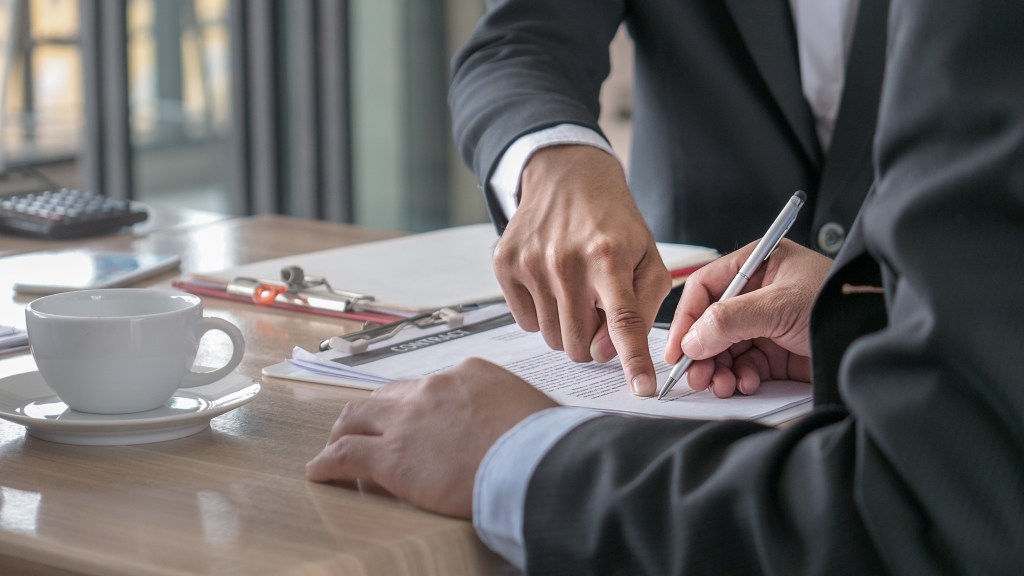 The selective and soft focused image of businessman is going to sign the contract in the business meeting.